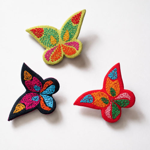 Handmade and hand embroidered textile brooch in form of butterflies