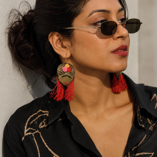 Model wearing a Frida Kahlo inspired handmade textile hook earrings.