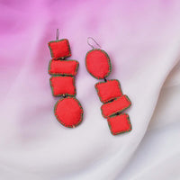 Flatlay of Handcrafted asymmetric shapes Nirali earrings in Red color.