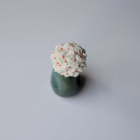Top shot of the Shiuli handcrafted hair accessory to show the tiny fabric flowers all stitched together to form one beautiful hair accessory.