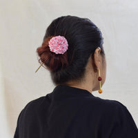 model wearing a shiuli fabric and metal bun stick in tiny baby pink flowers.