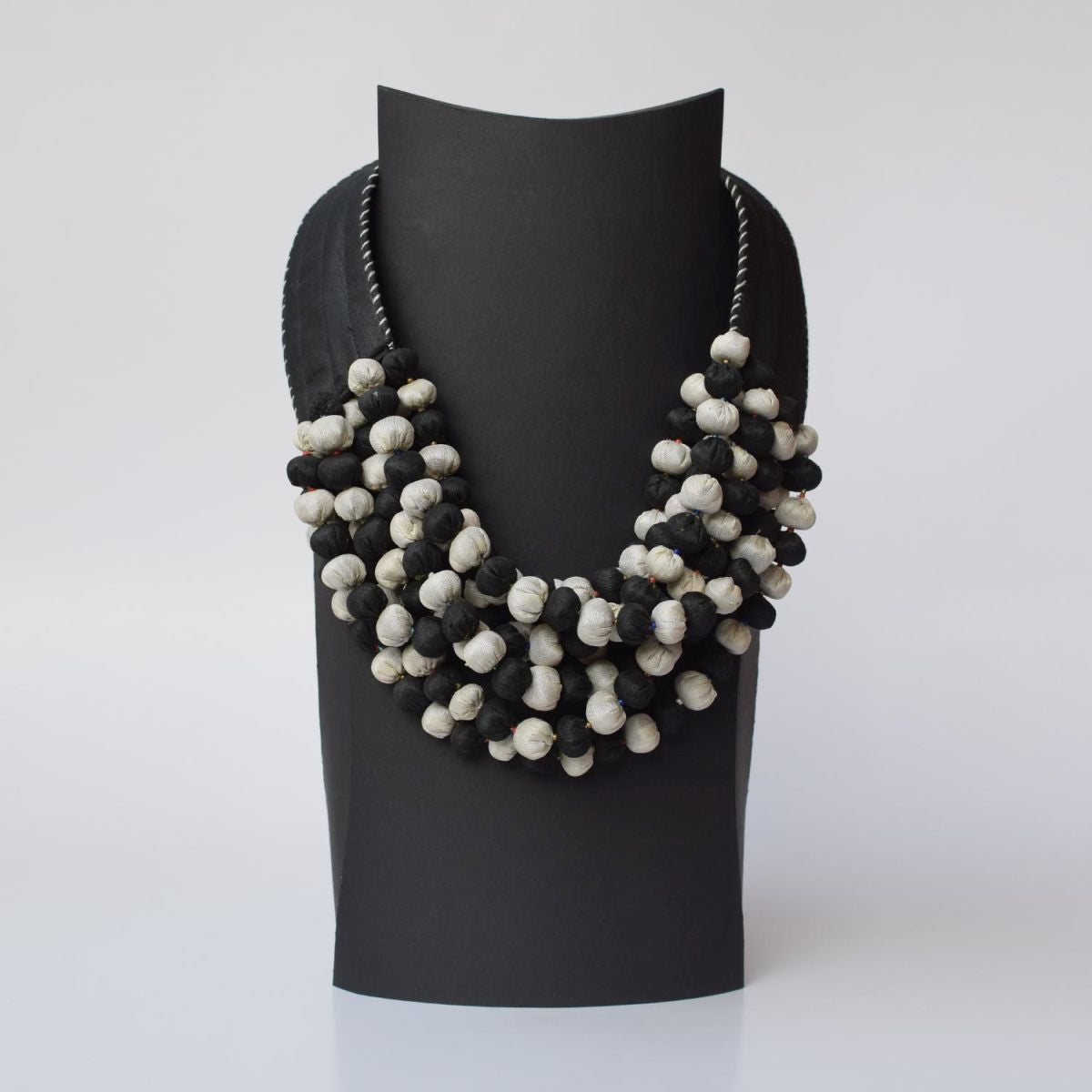 A closeup shot of handmade Ratna textile statement neckpiece.